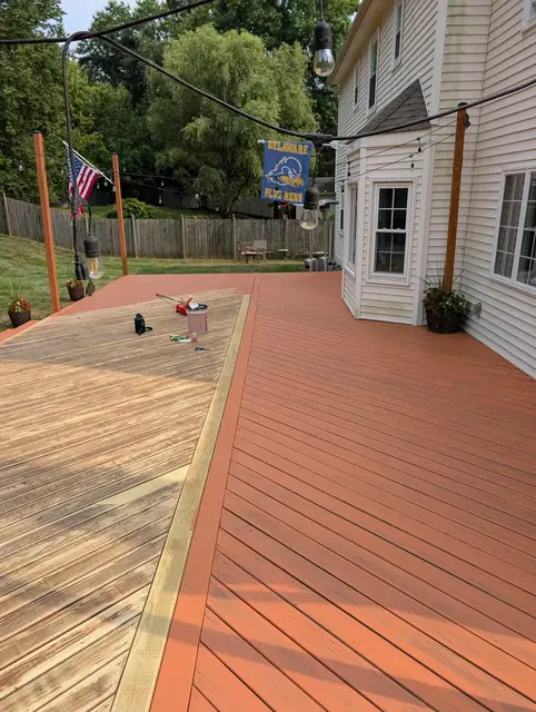 Solid-color stain being applied to a freshly sanded deck