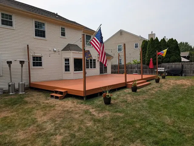 Fully restored backyard deck finished in a rich solid-color stain